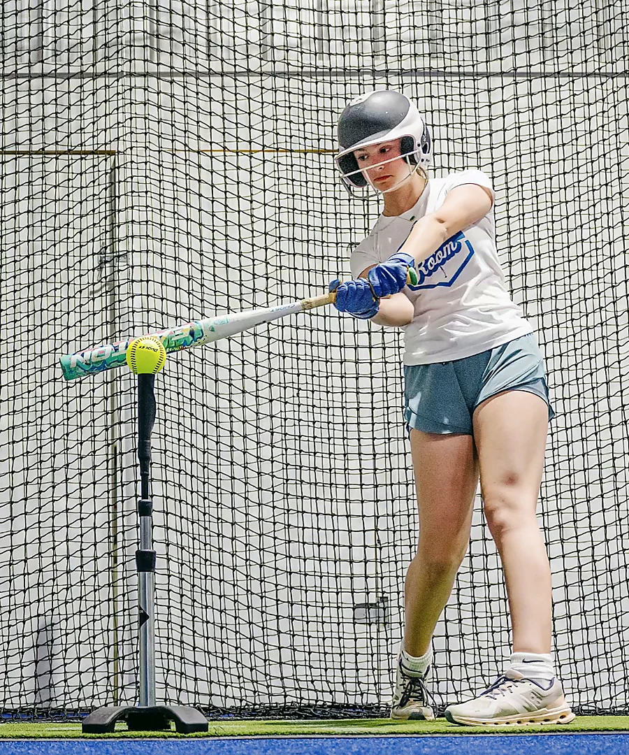 Softball athlete hitting inside The Boom Boom Room
